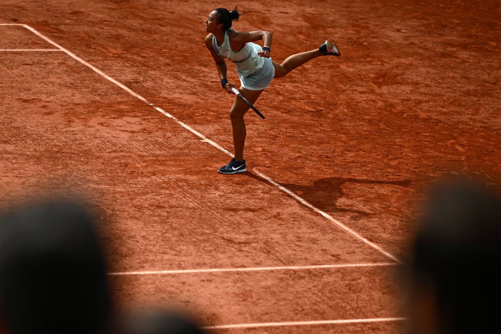 Zheng Qinwen serves to Simona Halep during their women’s singles match on day five of the Roland Garros tennis tournament. Photo: AFP