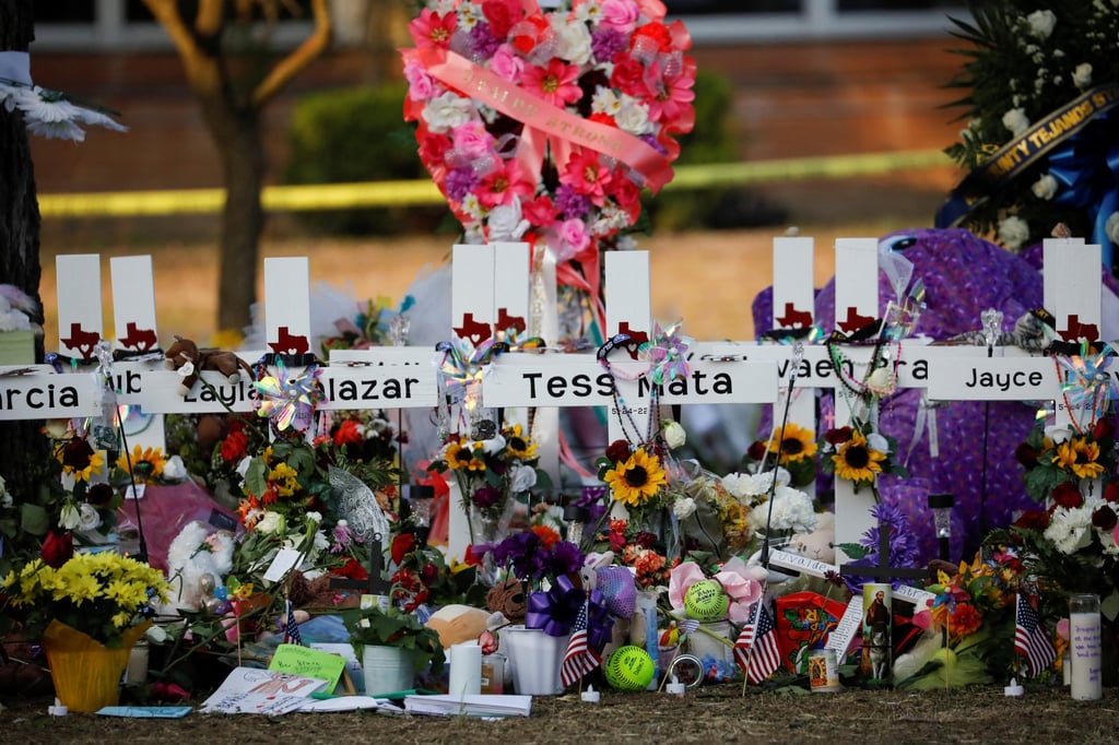 Flowers, candles and pictures are left in front of crosses with the names of victims of a school shooting, at a memorial outside Robb Elementary school in Uvalde, Texas, US on May 28. Photo: Reuters Flowers, candles and pictures are left in front of crosses with the names of victims of a school shooting, at a memorial outside Robb Elementary school in Uvalde, Texas, US on May 28. Photo: Reuters