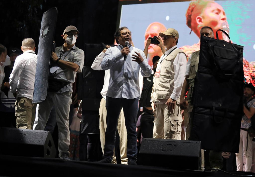 Surrounded by bodyguards holding bulletproof shields, presidential candidate Gustavo Petro speaks to supporters during a campaign rally this month. Photo: AP Surrounded by bodyguards holding bulletproof shields, presidential candidate Gustavo Petro speaks to supporters during a campaign rally this month. Photo: AP