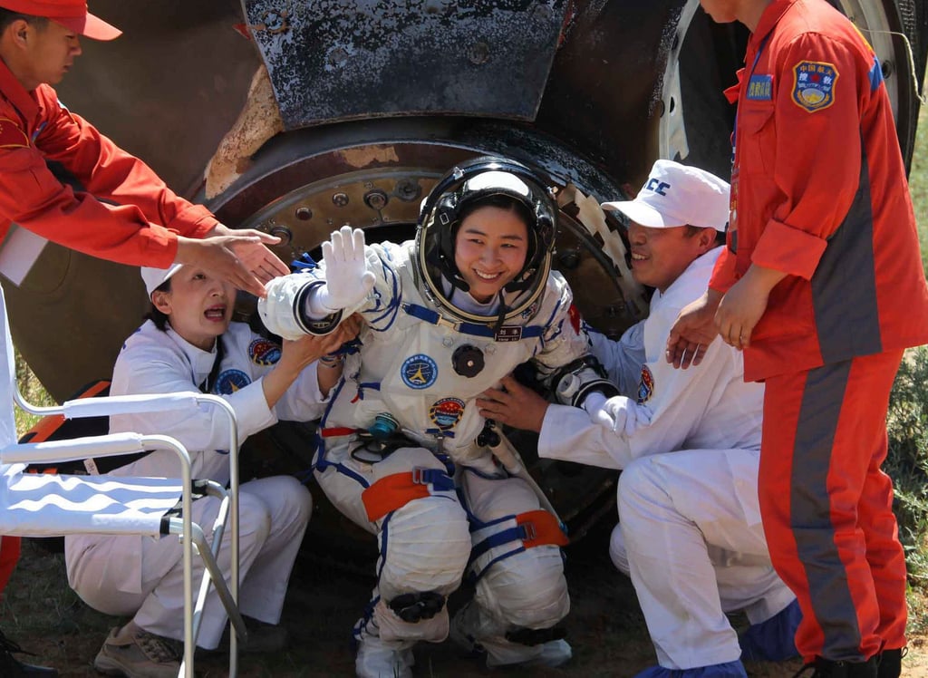 Liu Yang, the first Chinese woman to go into space, waves as she comes out of the re-entry capsule in 2012. Photo: AP