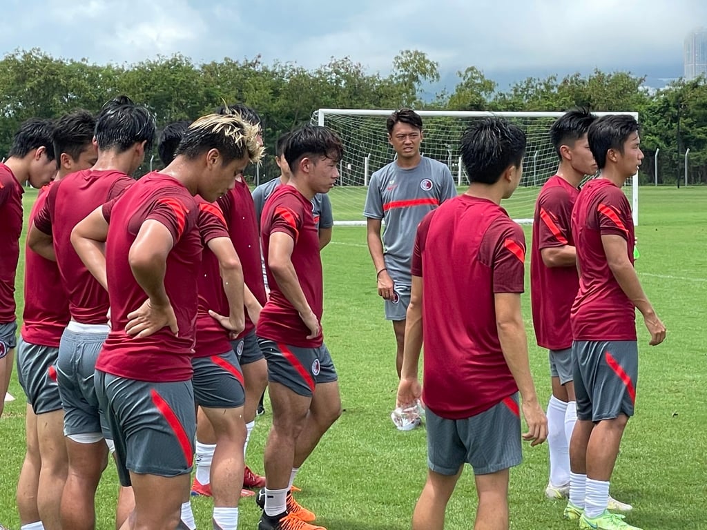 Coach Cheung Kin-fung (in grey) with his players at the training camp. Photo: Chan Kin-wa