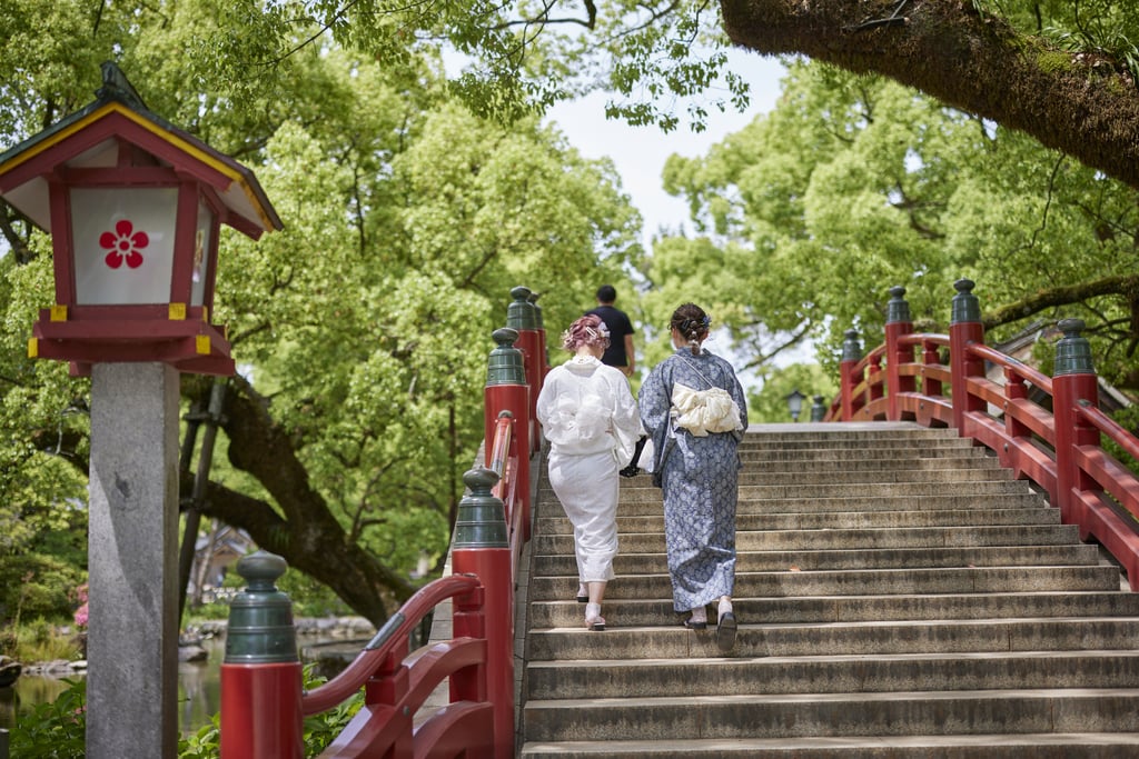 Women in traditional robes at a shrine in Japan. On June 10 package tours from overseas will start to bring tourists back to the country. Photo: Bloomberg