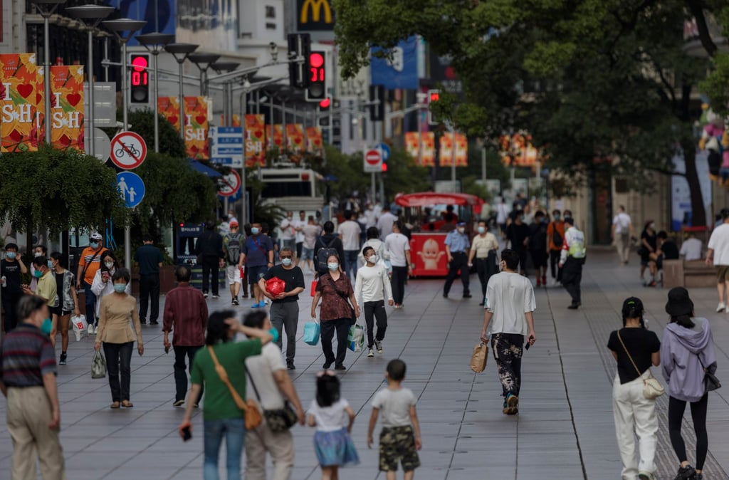 People walk along Nanjing Street in Shanghai on Thursday after the municipal government eased Covid-19 restrictions. Photo: EPA-EFE People walk along Nanjing Street in Shanghai on Thursday after the municipal government eased Covid-19 restrictions. Photo: EPA-EFE