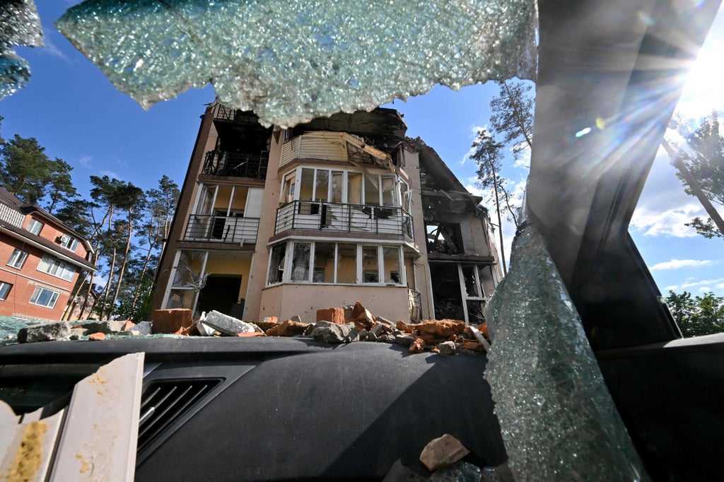 A residential building is seen through the wind shield of a destroyed car in the town of Irpin, northwest of Kyiv, on Friday. Photo: AFP A residential building is seen through the wind shield of a destroyed car in the town of Irpin, northwest of Kyiv, on Friday. Photo: AFP