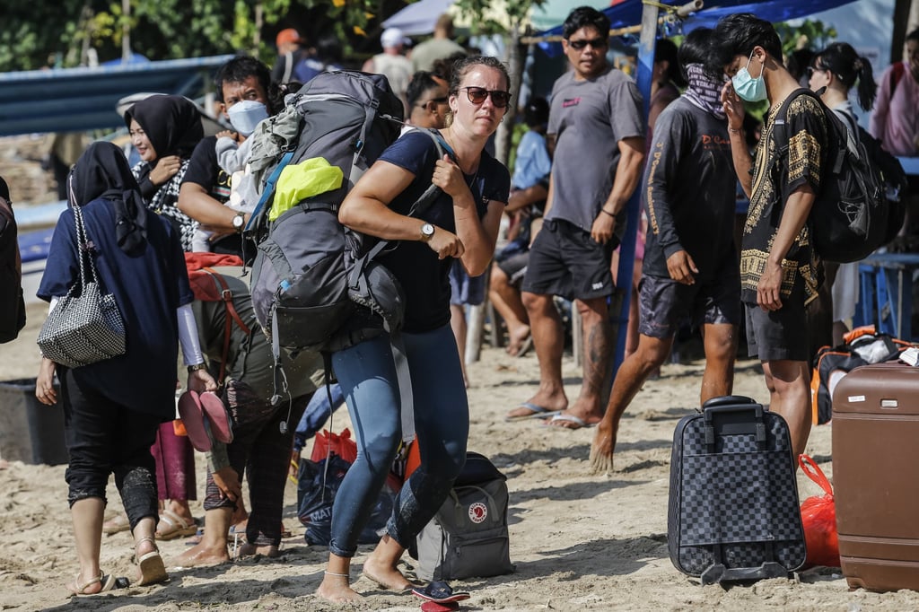 Tourists carry their bags as they disembark from a boat in Denpasar, Bali, Indonesia, last month Indonesia wants to draw higher-spending, longer-staying travellers. Photo: Johannes P. Christo/Anadolu Agency via Getty Images