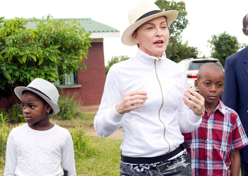 Madonna tours the Mphandura orphanage near Lilongwe, Malawi, with her two adopted children David Banda and Mercy James. Photo: AP Madonna tours the Mphandura orphanage near Lilongwe, Malawi, with her two adopted children David Banda and Mercy James. Photo: AP