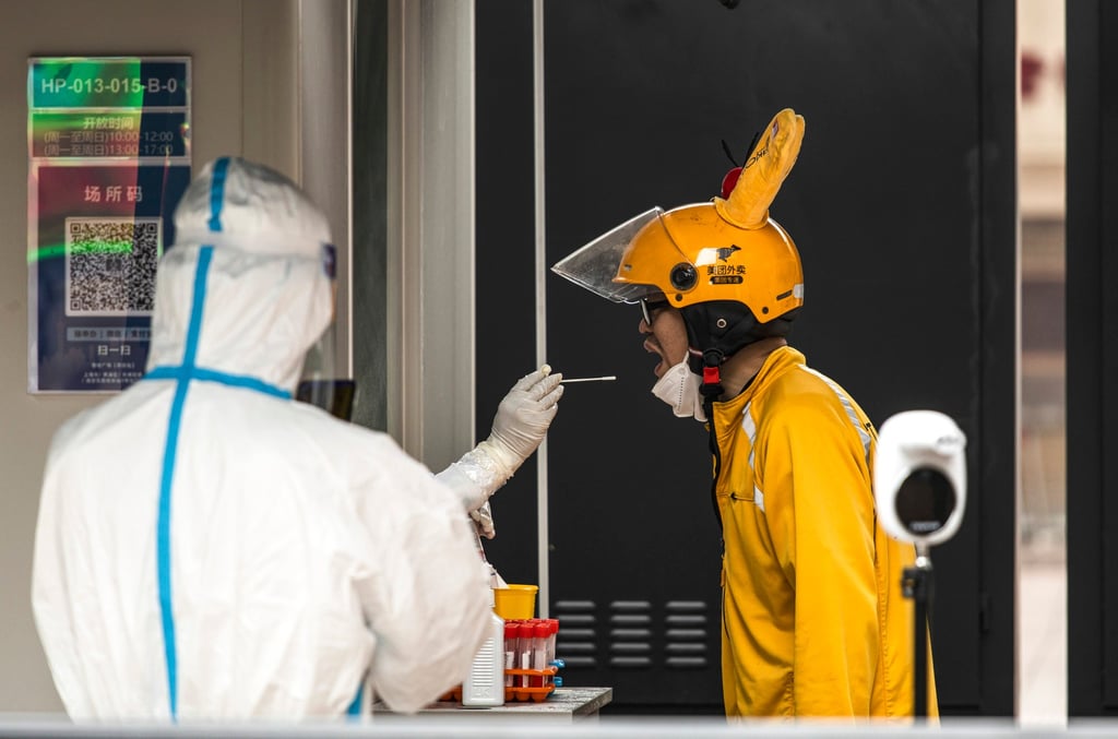 A delivery worker gets tested in Shanghai, one of many places setting up permanent testing sites. Photo: Bloomberg