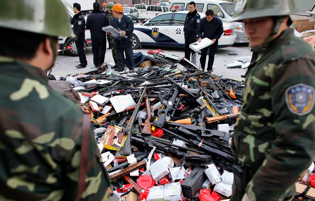 Police officers prepare to destroy confiscated weapons in Shanghai on December 29, 2009. Since the 1950s, China has diverged from the US by imposing strict anti-gun laws. Photo: Reuters