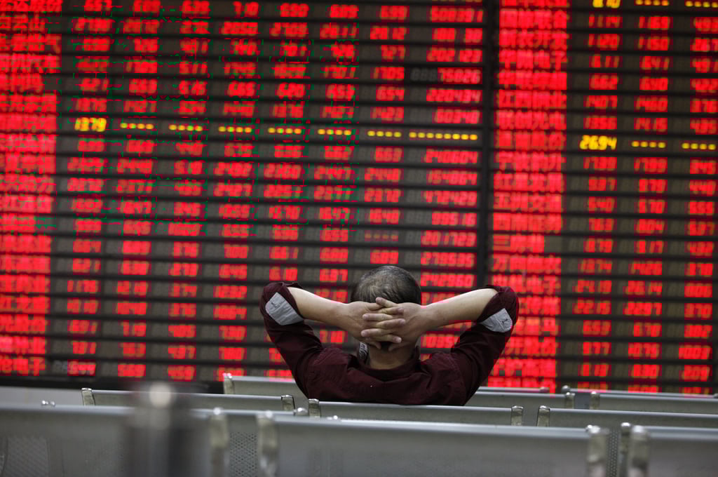 An investor watches stock prices board inside a brokerage house in Huaibei, Anhui province. Photo: Shutterstock