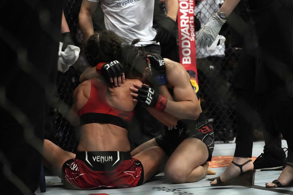 Zhang Weili embraces Joanna Jedrzejczyk after winning their strawweight bout at UFC 275 in Singapore. Photo: AFP
