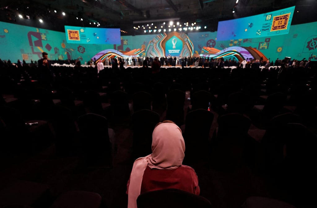A spectator watches the draw for the World Cup finals in Doha. Photo: Reuters A spectator watches the draw for the World Cup finals in Doha. Photo: Reuters