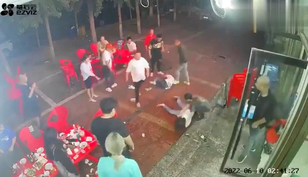 Two women lie on the ground after being assaulted by a group of men outside the restaurant in Tangshan in this screen grab taken from surveillance footage. Photo: Reuters
