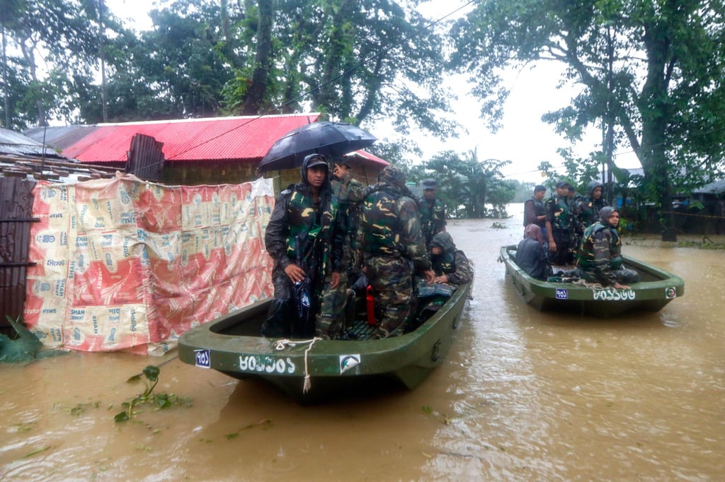 Bangladesh army personnel evacuate affected people from a flooded area on Saturday. Photo: AFP Bangladesh army personnel evacuate affected people from a flooded area on Saturday. Photo: AFP