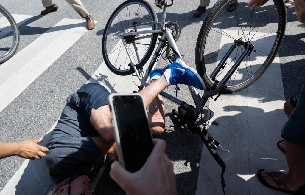 US President Joe Biden falls off his bicycle at Gordon’s Pond State Park in Rehoboth Beach, Delaware on Saturday. Photo: AFP