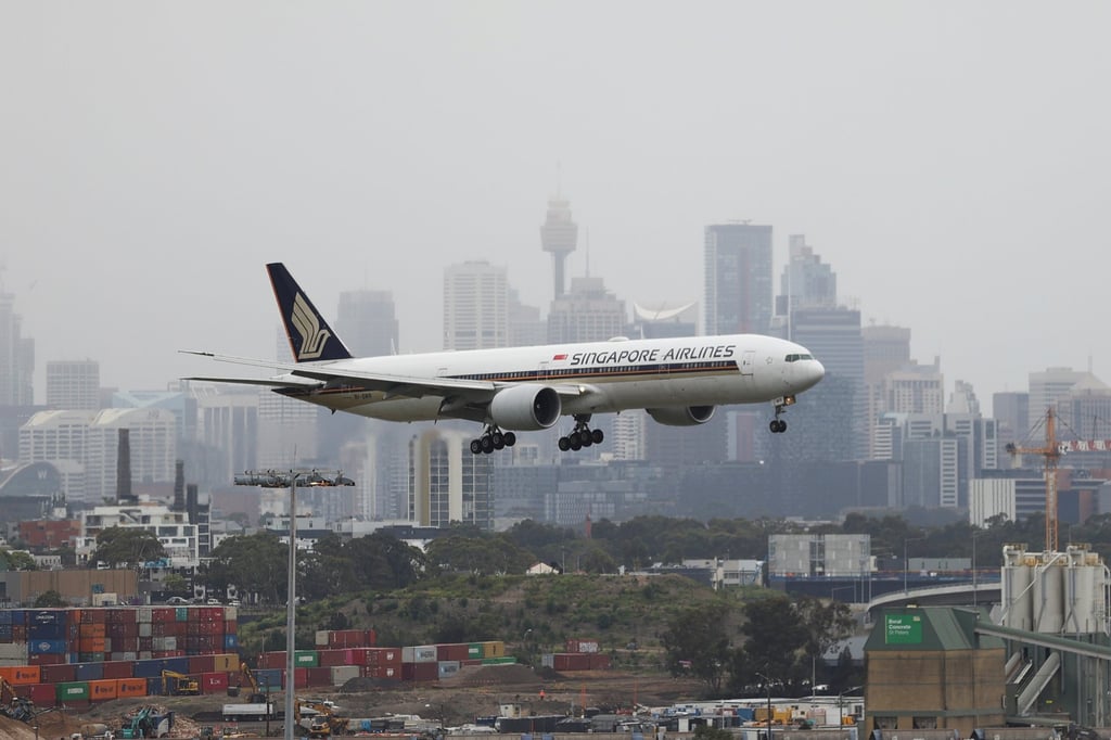 A Singapore Airlines plane lands at the international terminal of Sydney Airport. Photo: Reuters A Singapore Airlines plane lands at the international terminal of Sydney Airport. Photo: Reuters