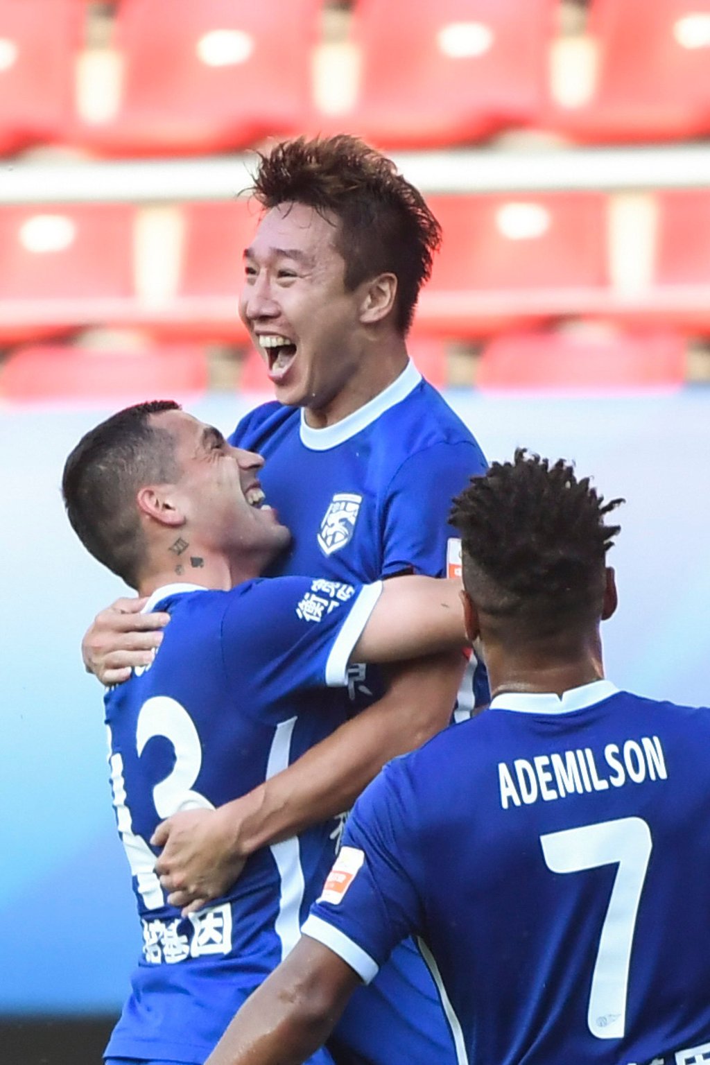 Ren Hang (top) of Wuhan Three Towns celebrates after scoring against Shanghai Port in Dalian. Photo: Xinhua