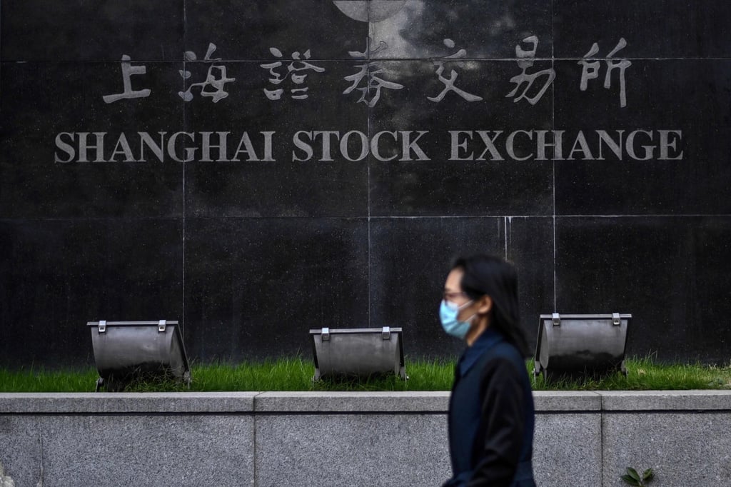 A pedestrian walks past the Shanghai Stock Exchange in Shanghai on November 4, 2020.s (Photo by Hector RETAMAL / AFP) A pedestrian walks past the Shanghai Stock Exchange in Shanghai on November 4, 2020.s (Photo by Hector RETAMAL / AFP)