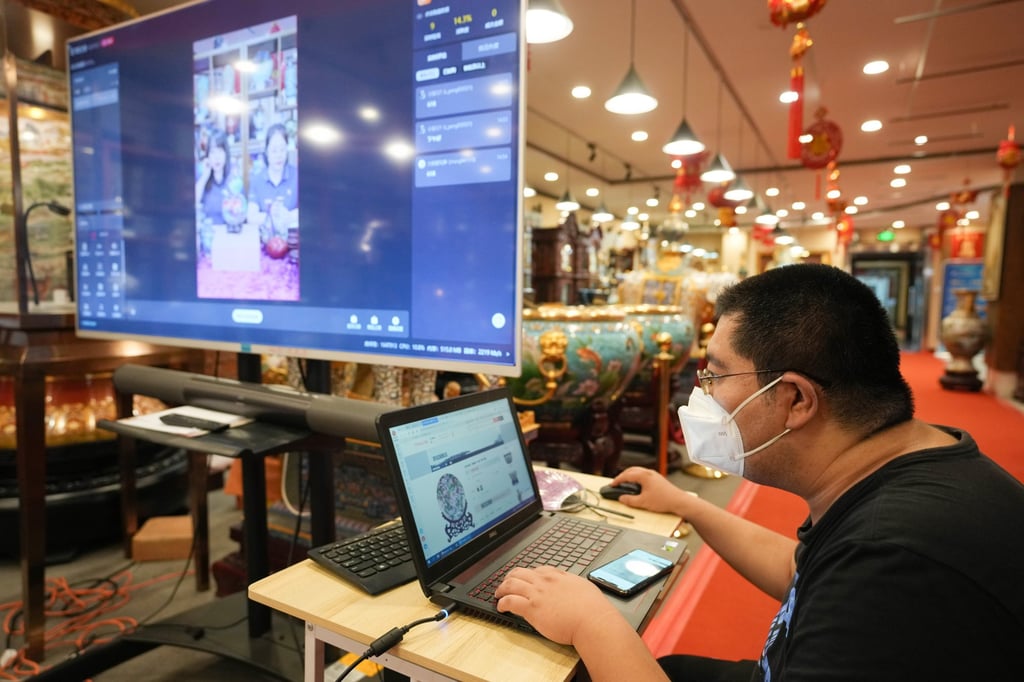 A staff member of an online shop runs a live-streaming session at an enamel factory in Beijing. Photo: Xinhua A staff member of an online shop runs a live-streaming session at an enamel factory in Beijing. Photo: Xinhua