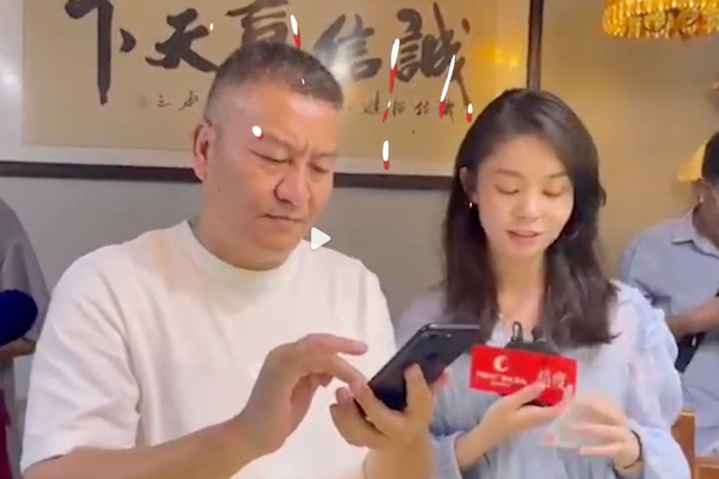 Sadly for Liang, seen here getting his 2022 scores, the 26th time he took the test did not yield the desired results. Photo: Weibo