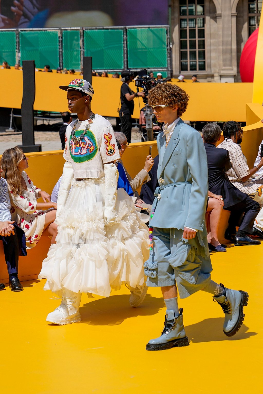 Models wearing a suit coat paired with shorts, and a gender-bending ruffled skirt, as part of the Louis Vuitton men’s spring/summer 2023 collection presented in Paris, France, on June 23. Photo: AP Photo Models wearing a suit coat paired with shorts, and a gender-bending ruffled skirt, as part of the Louis Vuitton men’s spring/summer 2023 collection presented in Paris, France, on June 23. Photo: AP Photo