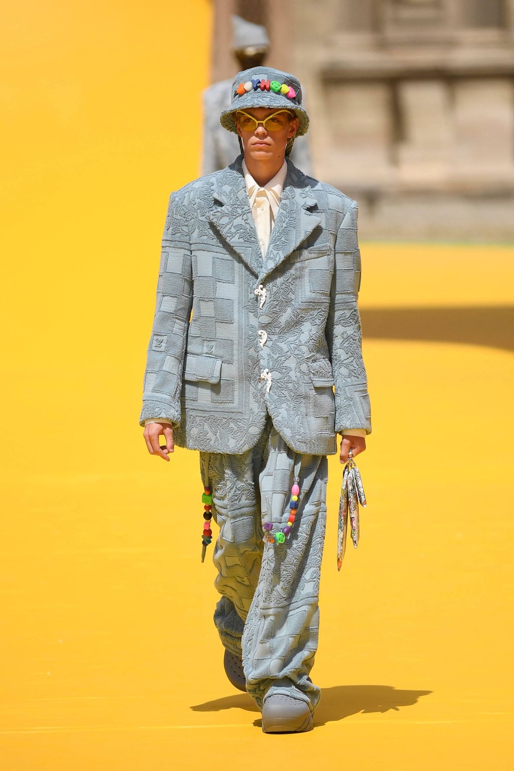 Nostalgic touches evoking childhood were present at Louis Vuitton’s menswear spring/Summer 2023 show, as part of Paris Fashion Week, in Paris, on June 23, such as the colourful beads and decorations seen here. Photo: AFP Nostalgic touches evoking childhood were present at Louis Vuitton’s menswear spring/Summer 2023 show, as part of Paris Fashion Week, in Paris, on June 23, such as the colourful beads and decorations seen here. Photo: AFP