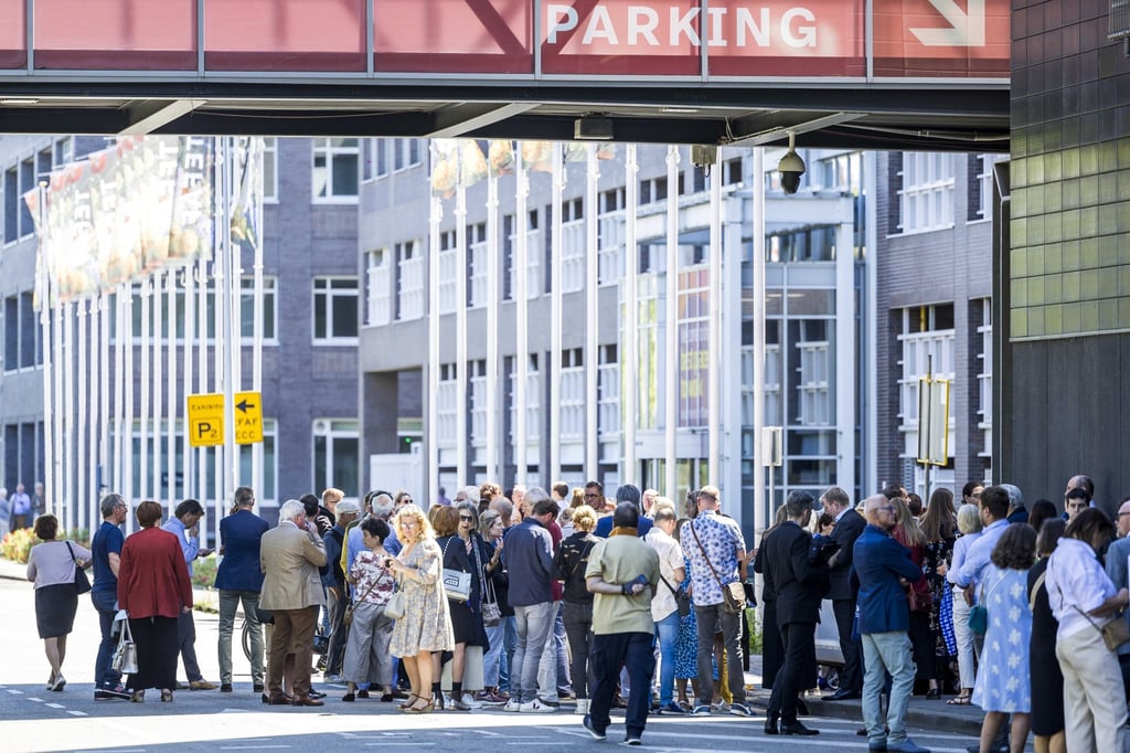 Visitors stand outside The European Fine Art Fair in Maastricht after it was evacuated following a raid on Tuesday. Photo: EPA-EFE