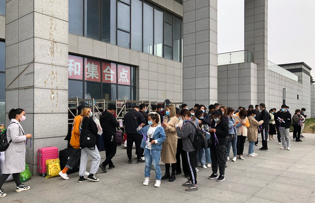 Jobseekers form a queue outside Foxconn Technology Group’s gathering point for new recruits in Zhengzhou, capital of central Henan province, on October 15, 2020. Photo: SCMP