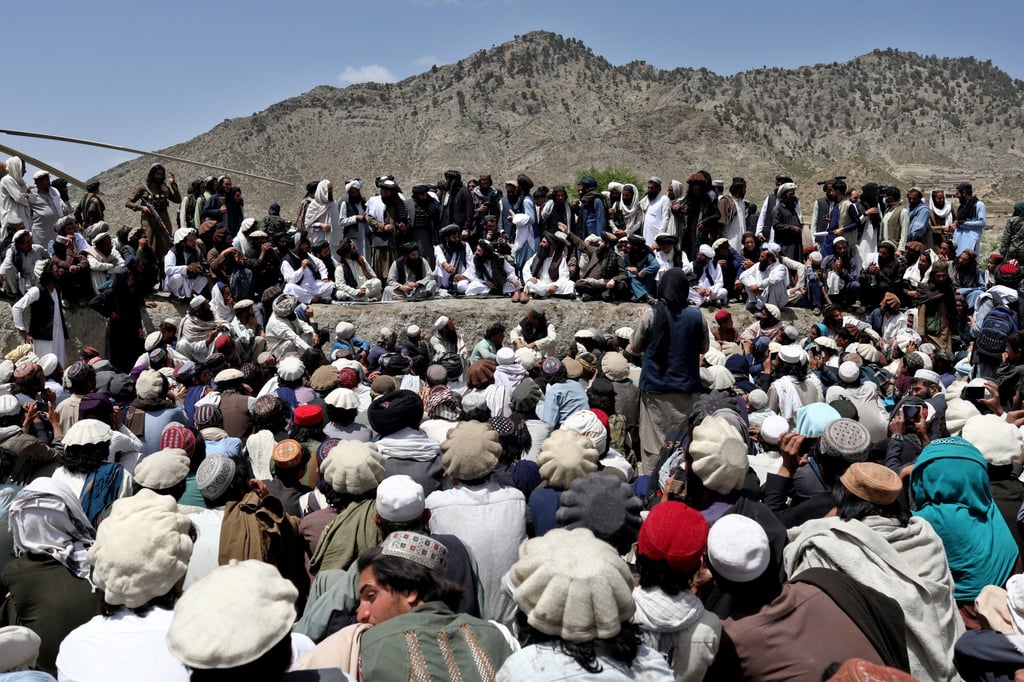 Afghan people wait to receive aid in an area affected by the earthquake in Gayan. Photo: Reuters
