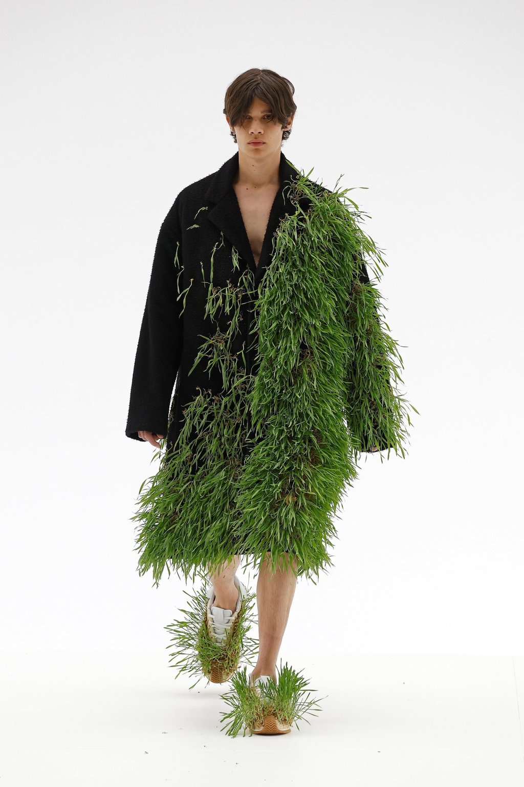 Grass appeared to grow out of clothing and shoes presented by Loewe for its spring/summer 2023 menswear collection, presented during Paris Fashion Week, on June 25. Photo: Xinhua