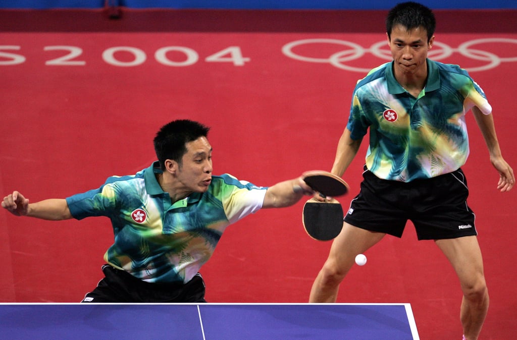 Ko Lai-chak (left) returns the ball while teammate Li Ching looks on as Hong Kong earn their only medal of the Athens Olympics. Photo: AP