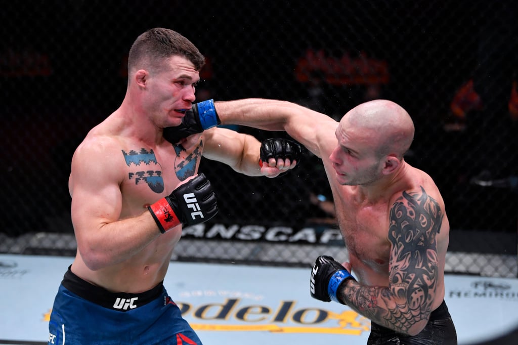 Sasha Palatnikov punches Louis Cosce in their welterweight bout at UFC 255 in Las Vegas. Photo: Jeff Bottari