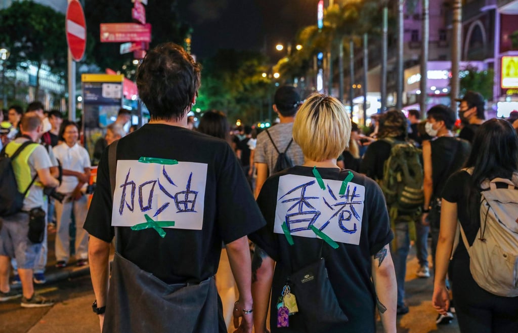 Protesters with placards reading “Hong Kong, add oil” in 2019. Photo: Sam Tsang