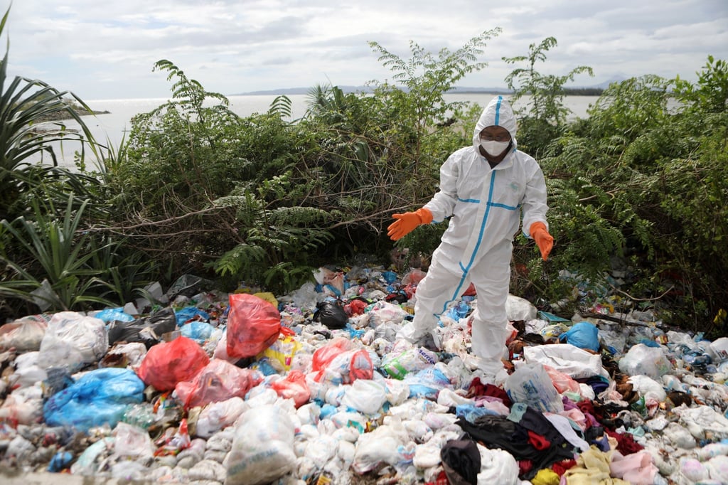An environmental activist inspects a polluted river in Aceh, Indonesia, last month. Photo: EPA-EFE