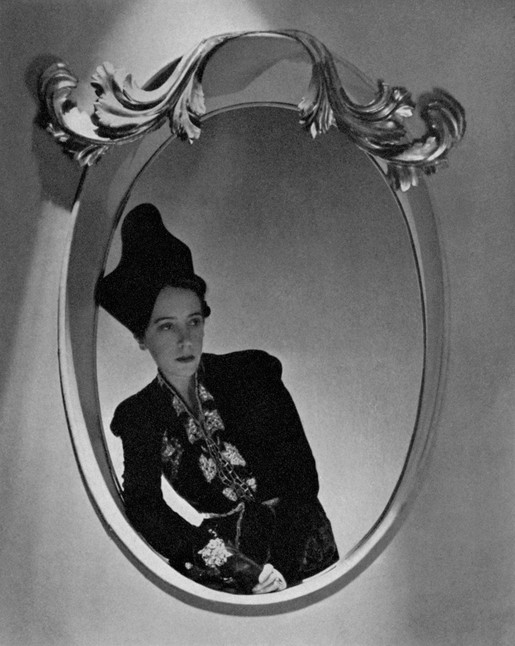 Elsa Schiaparelli, reflected in a mirror, wearing one of her ensembles. Photo: Condé Nast Archive/Corbis