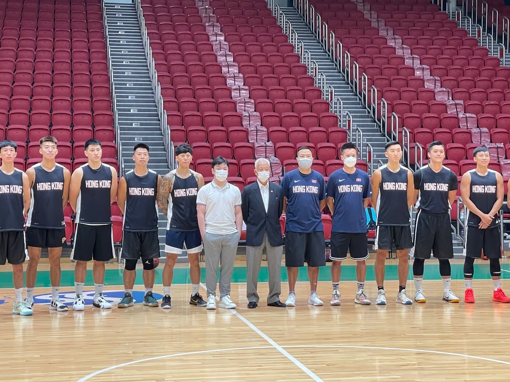 Jerry Chan (in white) and Mok Yiu-keung (in suit) of Hong Kong Basketball Association with the training squad for the 2025 Asia Cup qualifiers. Photo: Chan Kin-wa