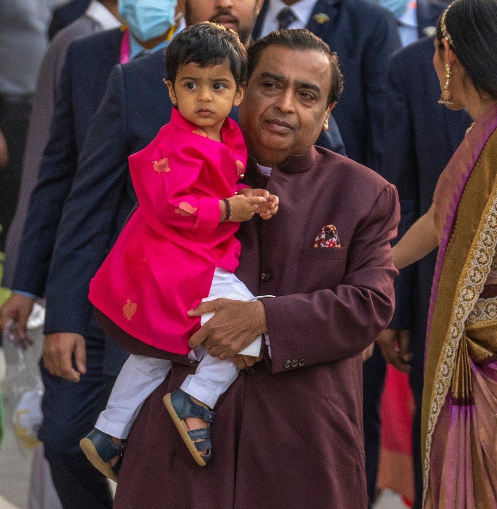 Reliance Industries Limited chairman Mukesh Ambani carries his grandson Prithvi Akash Ambani as he arrives to attend a classical dance performance in Mumbai, India, on June 5. Photo: AP