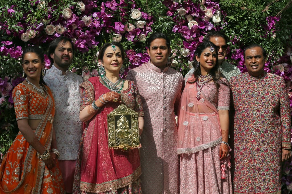 Radhika Merchant, Anant Ambani, Nita Ambani, Akash Ambani, Isha Piramal, Anand Piramal and Mukesh Ambani, the chairman of Reliance Industries, pose during a photo opportunity at the wedding ceremony of Akash, at Bandra-Kurla Complex in Mumbai, India, in March 2019. Photo: Reuters