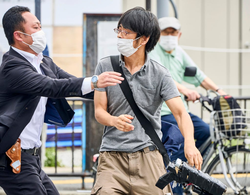 Tetsuya Yamagami, centre, is seen holding a weapon (bottom-right), while being detained in Nara on Friday. Photo: Kyodo News via AP Tetsuya Yamagami, centre, is seen holding a weapon (bottom-right), while being detained in Nara on Friday. Photo: Kyodo News via AP