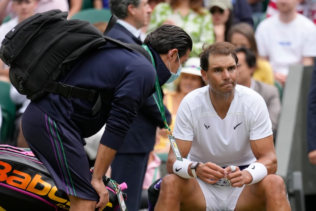 Rafael Nadal receives treatment just before a medical timeout as he plays Taylor Fritz in a men’s singles quarter-final at Wimbledon. Photo: AP Rafael Nadal receives treatment just before a medical timeout as he plays Taylor Fritz in a men’s singles quarter-final at Wimbledon. Photo: AP