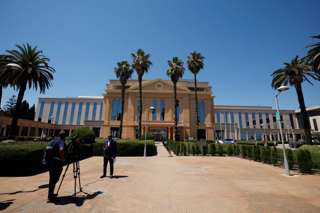 Journalists report from outside Clinica Teknon, in Spain’s Barcelona, where former Angolan leader Jose Eduardo dos Santos died on Friday. Photo: Reuters