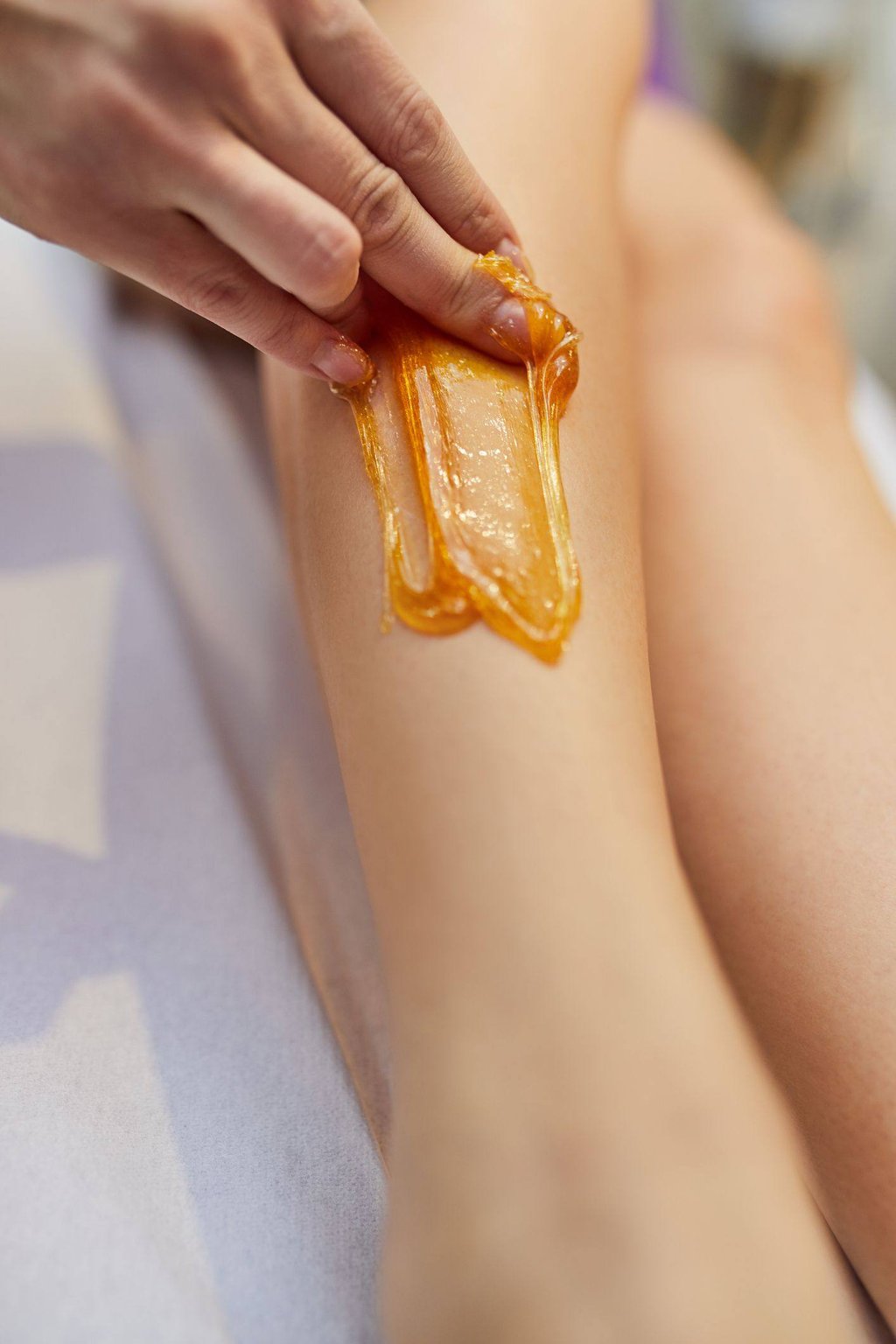 Sugaring uses sugar, lemon juice, and water to pull the hair from the follicle.