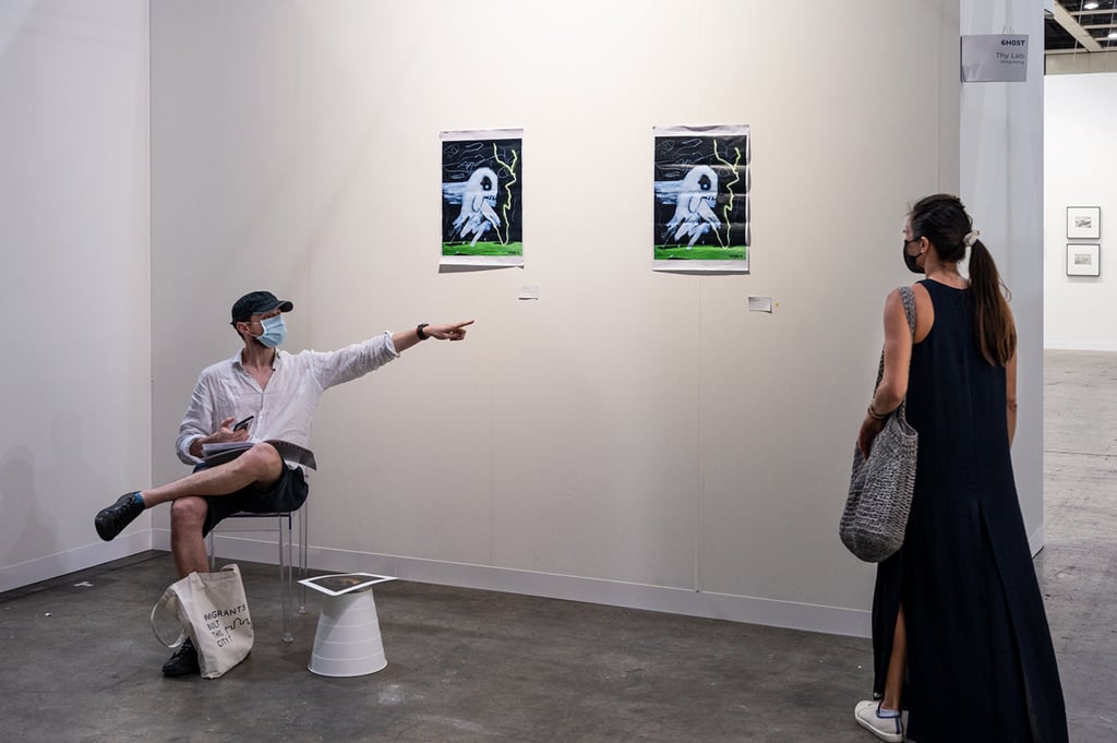 Alberto Gerosa (left) in the ghost booth he set up surreptitiously inside the 2021 Art Basel Hong Kong art fair. Photo: Thy Lab