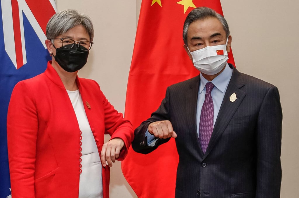 Australia’s Foreign Minister Penny Wong bumps elbows with China’s Foreign Minister Wang Yi during their meeting on Friday in Bali. Photo: AFP