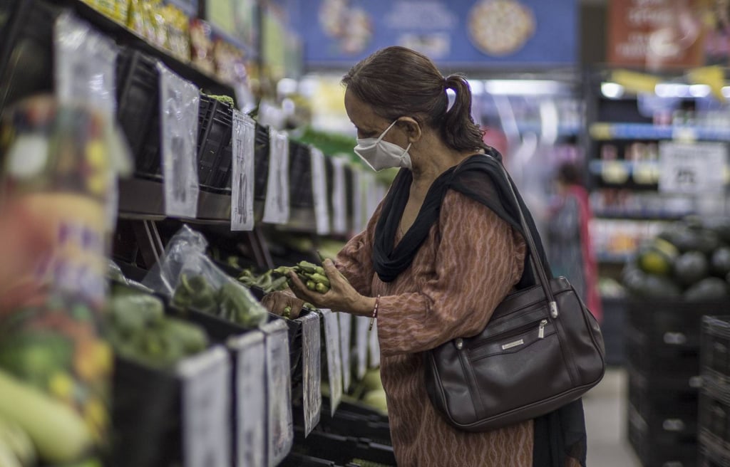 A customer shops for vegetables in a supermarket in New Delhi, India. Photo: Bloomberg