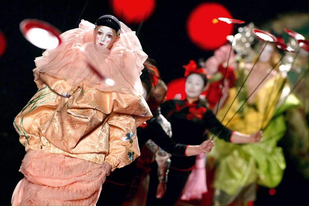 A Caucasian model in geisha-style make-up and a silk dress, designed by John Galliano, walks the Christian Dior spring/summer 2003 haute couture runway in Paris. Photo: AFP
