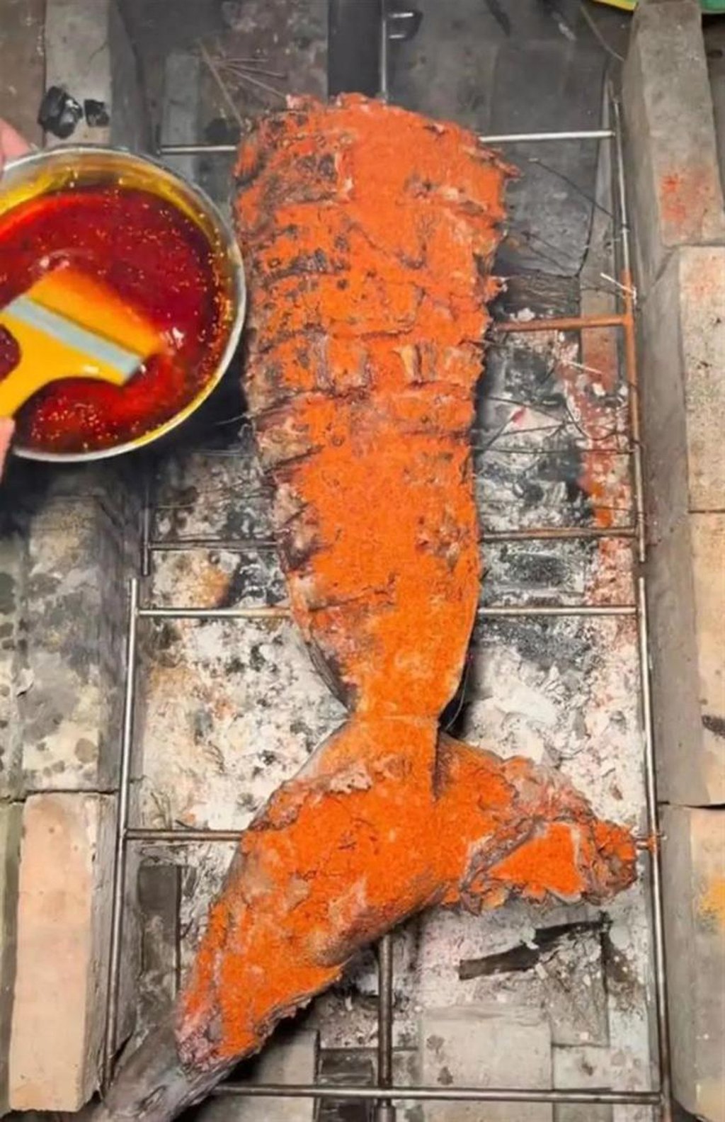 A potentially offensive shark’s tale covered in spices getting prepped to be cooked. Photo: Weibo