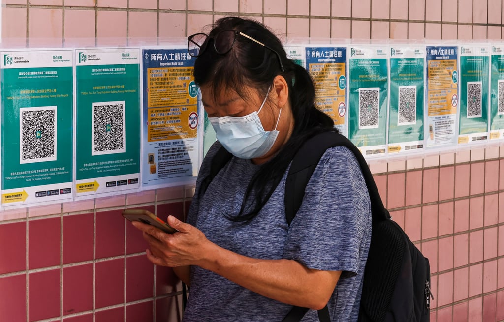 A woman uses the Leave Home Safe app at Kwong Wah Hospital, Mong Kok, on June 13. Photo: K.Y. Cheng A woman uses the Leave Home Safe app at Kwong Wah Hospital, Mong Kok, on June 13. Photo: K.Y. Cheng
