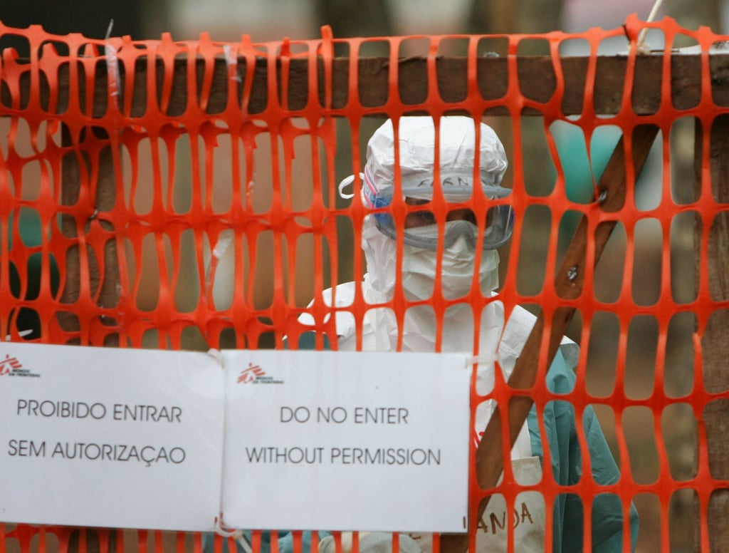 A health worker in protective clothing peers out from behind barriers marking the isolation ward where victims of the deadly Marburg virus are treated in Angola in 2005. Photo: File/Reuters A health worker in protective clothing peers out from behind barriers marking the isolation ward where victims of the deadly Marburg virus are treated in Angola in 2005. Photo: File/Reuters