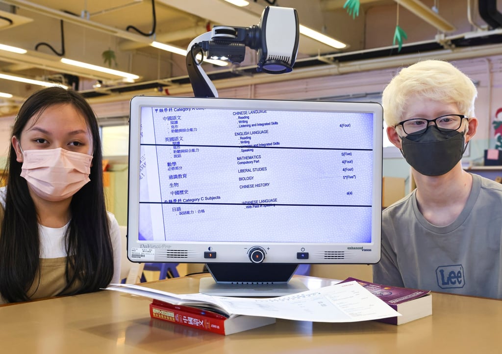 Students Leung and Wong show off their school’s closed circuit magnifier, which helps with reading study materials. Photo: K. Y. Cheng Students Leung and Wong show off their school’s closed circuit magnifier, which helps with reading study materials. Photo: K. Y. Cheng