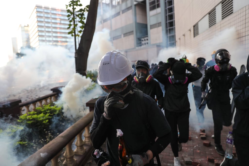 Protestors are met by rounds of tear gas fired by police guarding around the Polytechnic University perimeter during the 2019 unrest. Photo: Sam Tsang